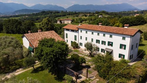 an aerial view of a large white building in a field at GATTO IN VIGNA in Susegana