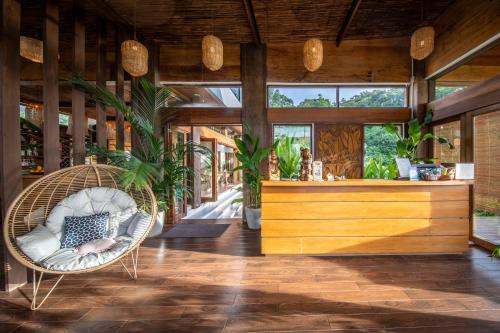 a room with a rattan chair and a bar at Ahana Resort El Nido in El Nido