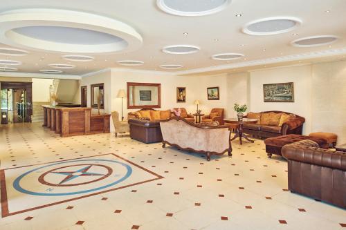 a large lobby with couches and chairs and a table at Palazetto Suites Zakynthos - Adults Only in Tsilivi