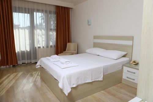 Postel nebo postele na pokoji v ubytování Hotel Binlik