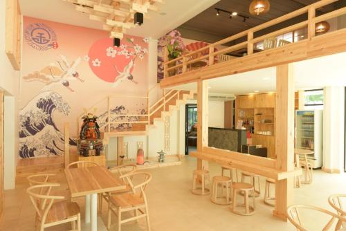 a dining room with a staircase and a mural on the wall at The Golden Ville Boutique Hotel and Spa in Pattaya