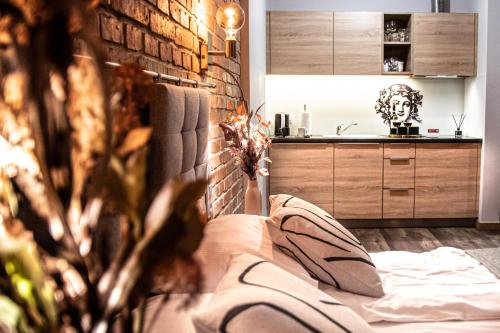 a living room with a bed and a kitchen at Wine Apartments in Kraków