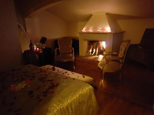 a room with a fireplace and a bed and a couch at Büyükada Anastasia Meziki History Mansion in Buyukada
