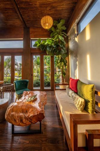 a living room with a couch and a table at Ahana Resort El Nido in El Nido