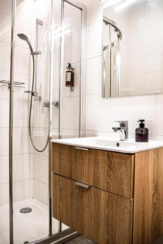 a bathroom with a sink and a shower at Wine Apartments in Kraków