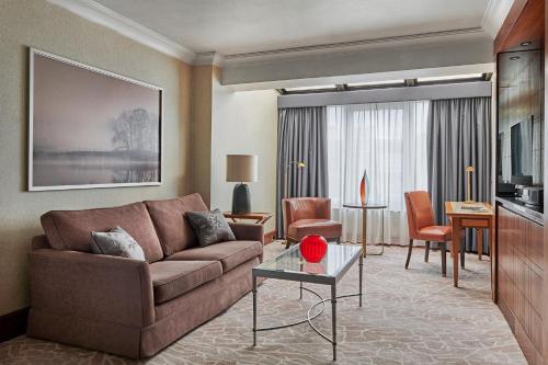 a living room with a couch and a table at InterContinental London Park Lane by IHG in London