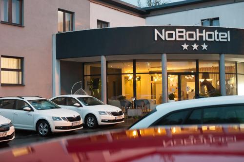 a nordica store with cars parked in front of it at NoBo Hotel - business in Łódź
