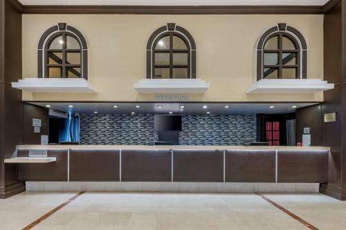 a lobby with a reception desk in a building at Ramada Plaza by Wyndham Marco Polo Beach Resort in Miami Beach