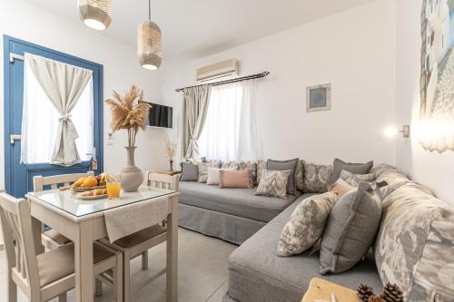 a living room with a couch and a table at Arhontiko in Naxos Chora