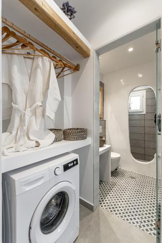 a laundry room with a washing machine in a bathroom at Arhontiko in Naxos Chora