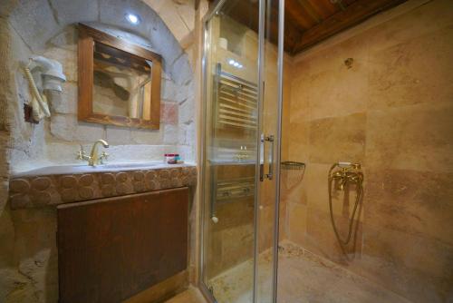 a bathroom with a shower and a sink at Fairyland Cave Hotel in Goreme