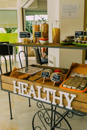 a bakery with a healthy sign on a table at Hotel Subur Maritim in Sitges