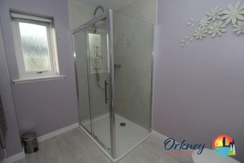 a shower with a glass door in a bathroom at Algarth, Stromness, Orkney - OR00218F in Stromness