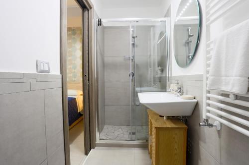 a bathroom with a shower and a sink and a mirror at Le stanze di Mami in Salerno