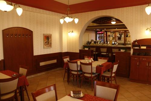 a restaurant with tables and chairs and a bar at Penzion Poříčí in Trutnov