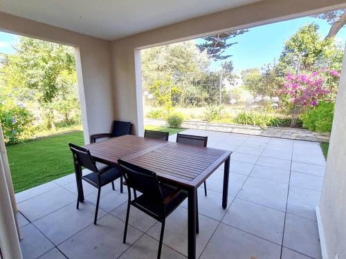 une salle à manger avec une table et des chaises et une grande fenêtre dans l'établissement T3 en rez-de-jardin avec Wi-Fi et Parking - Plages et commerces à 900m - Terrasse et Jardin privatif - FR-1-316-271, à Six-Fours-les-Plages