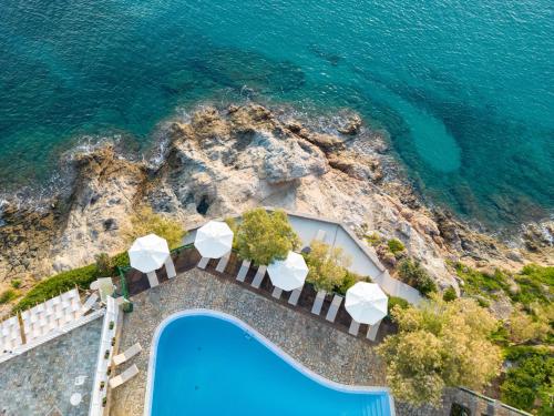 an aerial view of a swimming pool and the ocean at Erofili Beach Hotel in Armenistis