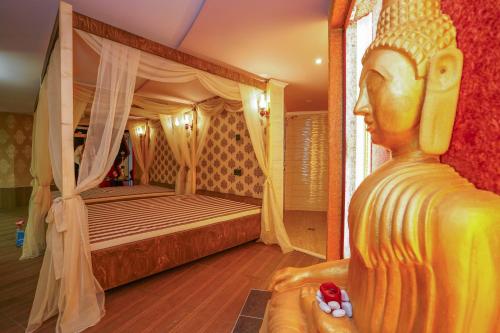 a bedroom with a bed with a statue in the foreground at Hotel Central Club Sofia in Sofia