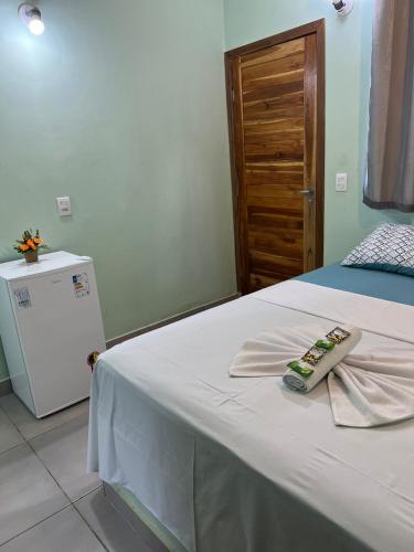 Un dormitorio con una cama con una toalla. en Pousada Certa Express en Chapada dos Guimarães