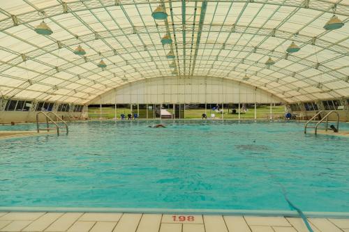 a large swimming pool with a glass ceiling at Shaar Hagolan Kibbutz Country Lodging in Shaar Hagolan