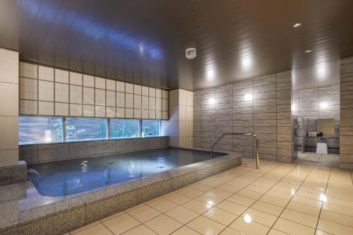 a large swimming pool in a building with at Keio Prelia Hotel Kyoto Karasuma-Gojo in Kyoto