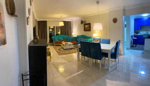 een eetkamer en een woonkamer met een tafel en stoelen bij Cozy in Giza 2 bedroom apartment in Caïro