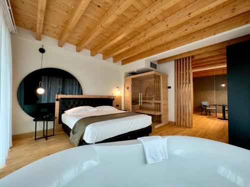 a bedroom with two beds and a tub in it at Hotel Master in Brescia