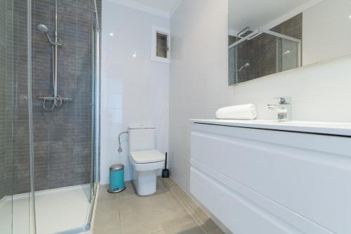 un bagno bianco con doccia e WC di Apartamento Ferrera Park 407 a Cala Ferrera