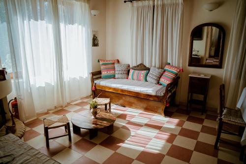 a living room with a couch and a table at Traditional Architecture Seafront Stone House in 25000sqm Olive Grove - C in Alyfantá