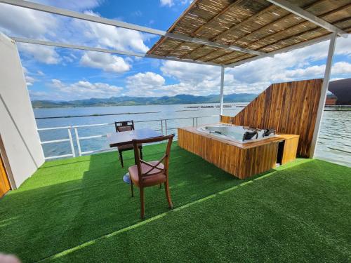 a deck of a boat with a table and a bath tub at บ้านไร่ วรรณ วาลย์ รีสอร์ท in Tha Kradan