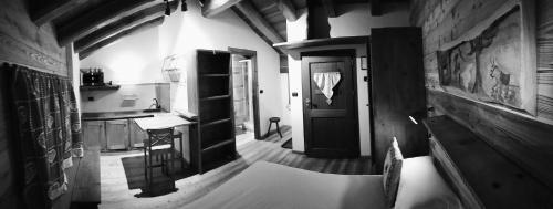 a kitchen with a hallway with a door and a table at BAITA Ancienne Bergerie in Valtournenche