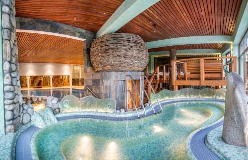 a swimming pool in a house with a pool at Hotel Partizán in Tale
