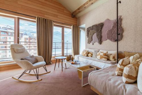 a living room with a bed and a chair at Altapura in Val Thorens