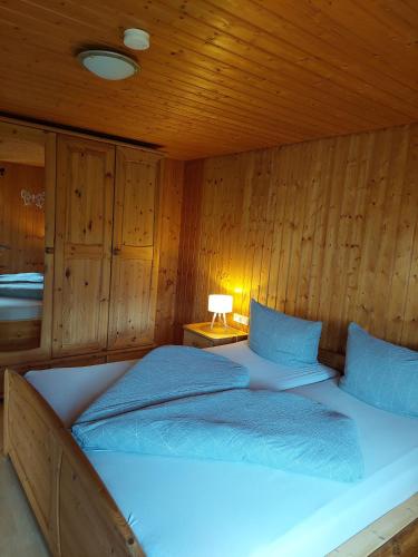 a bedroom with a bed in a wooden room at Urlaub an der Grenze in Lauterbach