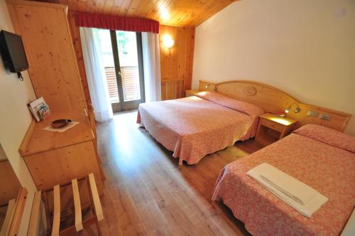 מיטה או מיטות בחדר ב-Hotel Rifugio Sores