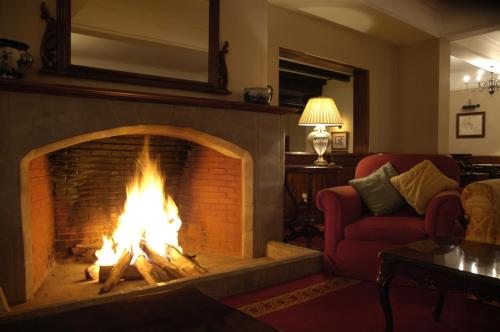 a fireplace in a living room with a fire at Arusha Serena Hotel in Nkoanrua