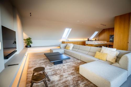 a living room with a couch and a table at The Penthouse Nami, Branding, Ultra Luxurious Japanese Design Sea View in Cadzand