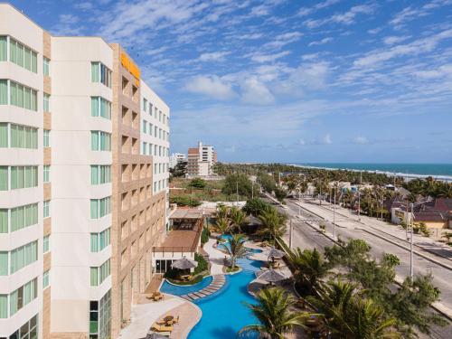 an aerial view of a resort with a pool and the ocean at Gran Mareiro Hotel in Fortaleza