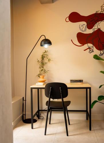 a desk with a black chair and a lamp at BlackBrick Sandton Two in Johannesburg