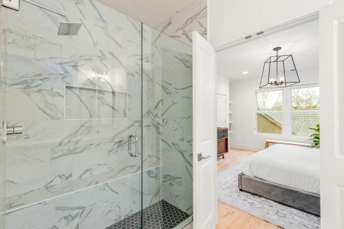 a bathroom with a shower with a glass door at Park West 7 in Nashville