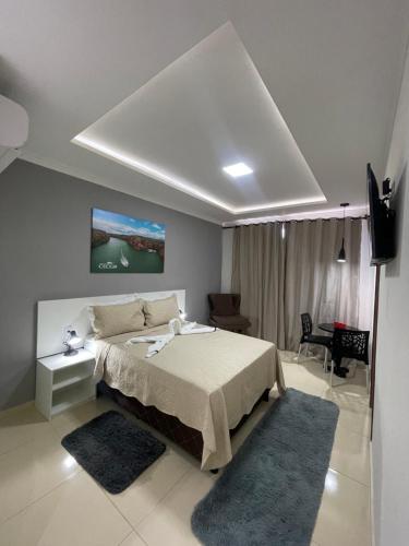 a bedroom with a large bed and a tv at POUSADA CECILIA in Canindé de São Francisco