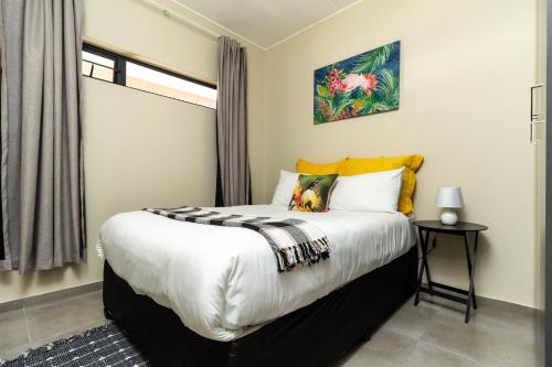 a bedroom with a large bed in a room at The Lillies Luxury Apartment in Midrand