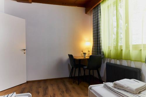a room with a table and chairs and a desk at The Art and Sporthotel in Innsbruck