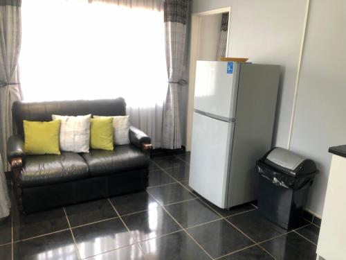 a living room with a couch and a refrigerator at 1 bed apartment in Mount Pleasant Heights - 2014 in Kingsmead
