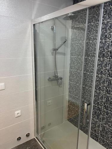 a shower with a glass door in a bathroom at Casa dos Doces in Póvoa de Lanhoso