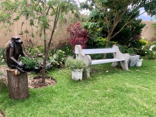 a statue of a bear next to a park bench at 1 bed apartment in Mount Pleasant Heights - 2014 in Kingsmead