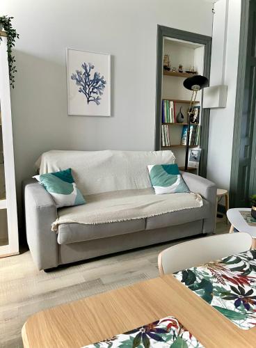un salon avec un canapé et une table dans l'établissement La Batelière, appartement mer avec patio privé, à Mers-les-Bains