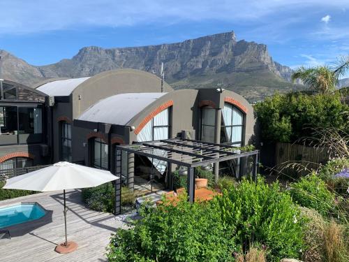 a house with a mountain in the background at Eagles Nest in Cape Town