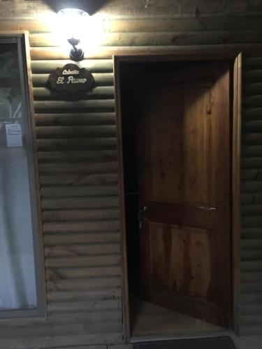 a door to a room with a sign on the wall at Cabañas Lihuén SPA in Parral