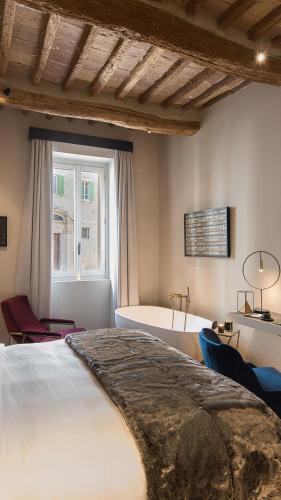 a bedroom with a large bed and a window at Times Suites in Perugia